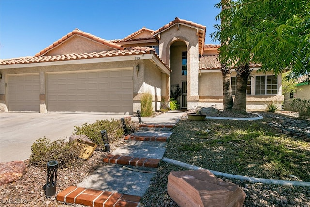 mediterranean / spanish-style home with a garage