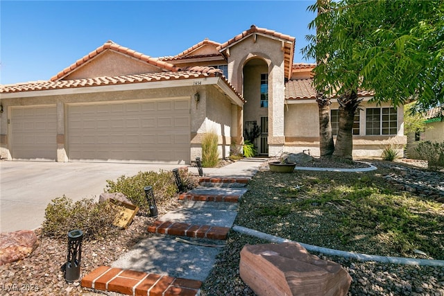 1834 Escondido Ter, Henderson, NV 89074 - mediterranean / spanish home featuring a tiled roof, stucco siding, driveway, and a garage