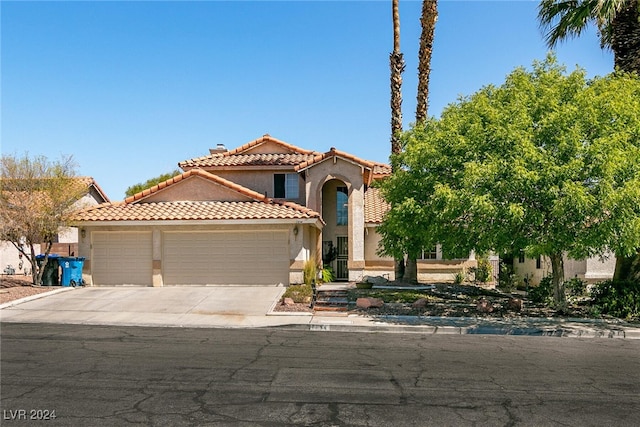 1834 Escondido Ter, Henderson, NV 89074 - mediterranean / spanish house featuring a tile roof, a garage, driveway, and stucco siding