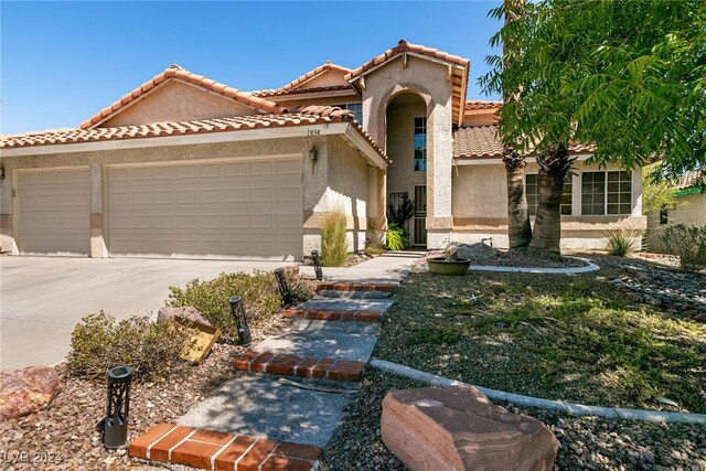 1834 Escondido Ter, Henderson, NV 89074 - mediterranean / spanish home featuring stucco siding, a garage, concrete driveway, and a tile roof