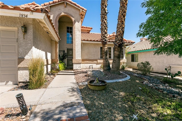 1834 Escondido Ter, Henderson, NV 89074 - doorway to property featuring stucco siding, a tiled roof, and a garage