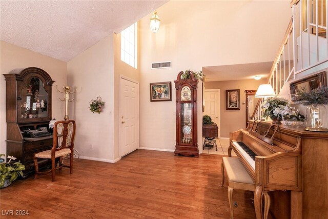 1834 Escondido Ter, Henderson, NV 89074 - entryway featuring visible vents, a textured ceiling, wood finished floors, baseboards, and a towering ceiling