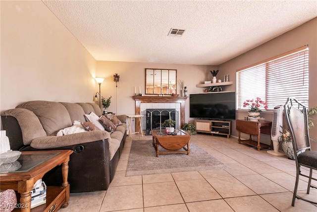 1834 Escondido Ter, Henderson, NV 89074 - living room featuring light tile patterned floors, visible vents, a tile fireplace, and a textured ceiling