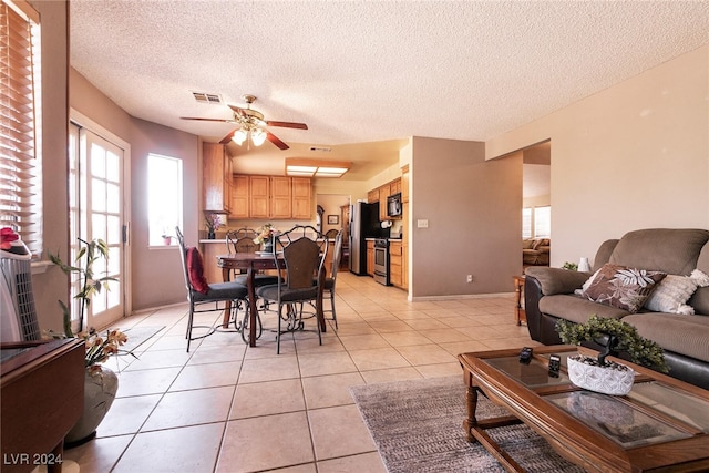 1834 Escondido Ter, Henderson, NV 89074 - dining space with visible vents, baseboards, light tile patterned floors, a textured ceiling, and a ceiling fan