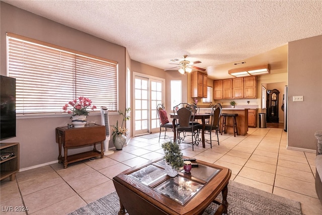 1834 Escondido Ter, Henderson, NV 89074 - living area with visible vents, a textured ceiling, light tile patterned flooring, baseboards, and ceiling fan