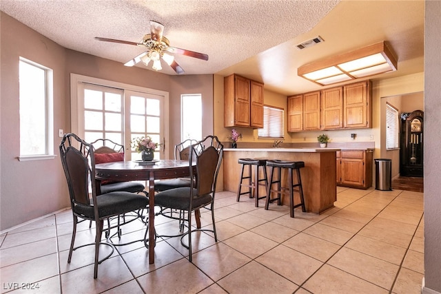 1834 Escondido Ter, Henderson, NV 89074 - dining space featuring light tile patterned floors, visible vents, a textured ceiling, and a ceiling fan