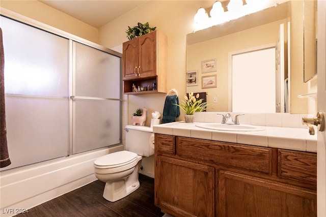 1834 Escondido Ter, Henderson, NV 89074 - bathroom with bath / shower combo with glass door, toilet, wood finished floors, and vanity
