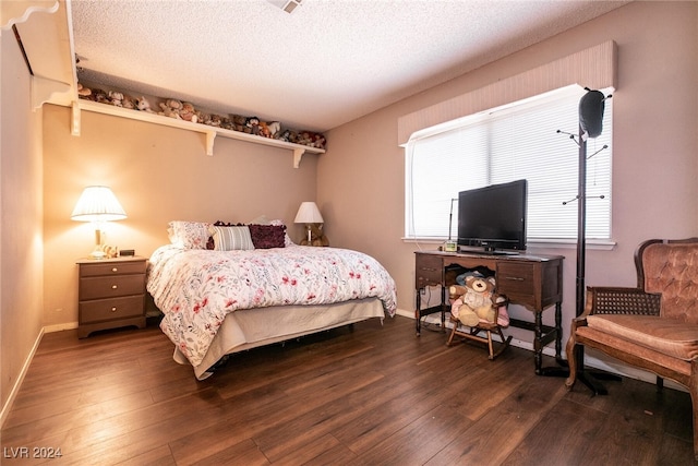 1834 Escondido Ter, Henderson, NV 89074 - bedroom featuring baseboards, a textured ceiling, and dark wood-style flooring