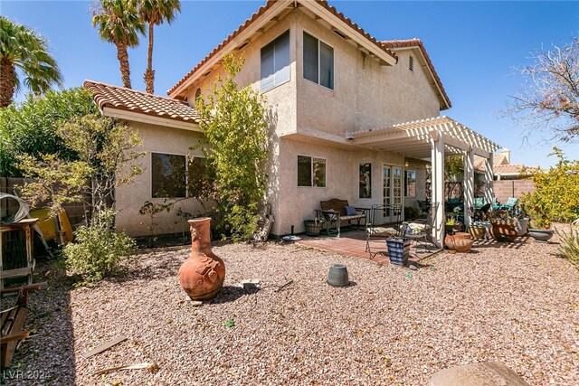 1834 Escondido Ter, Henderson, NV 89074 - rear view of property featuring stucco siding, a pergola, a tile roof, fence, and a patio area