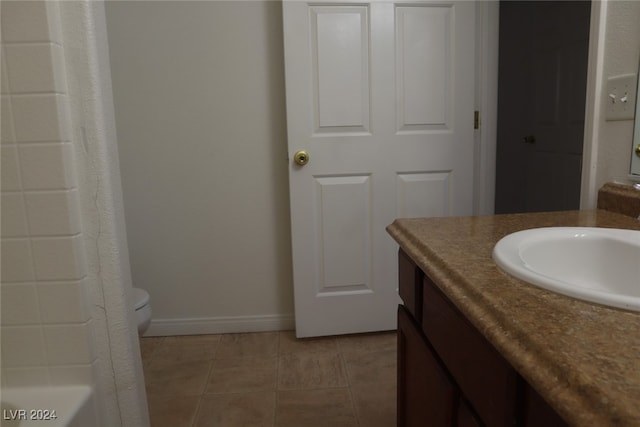 full bathroom featuring tile patterned flooring, plus walk in shower, vanity, and toilet