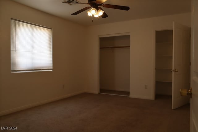 unfurnished bedroom with ceiling fan and carpet