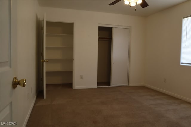 unfurnished bedroom featuring ceiling fan, light carpet, and multiple windows