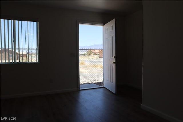 doorway to outside featuring plenty of natural light and dark hardwood / wood-style floors