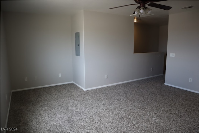 empty room with ceiling fan, carpet floors, and electric panel