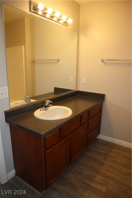 bathroom with vanity and wood-type flooring