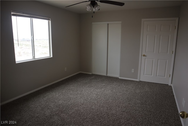 unfurnished bedroom featuring ceiling fan and carpet flooring