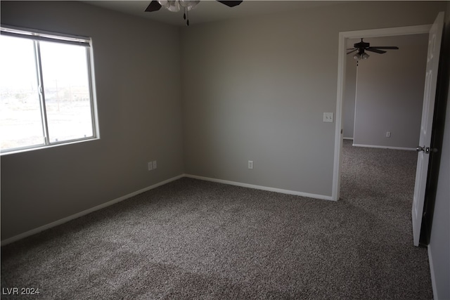 unfurnished room with ceiling fan and carpet