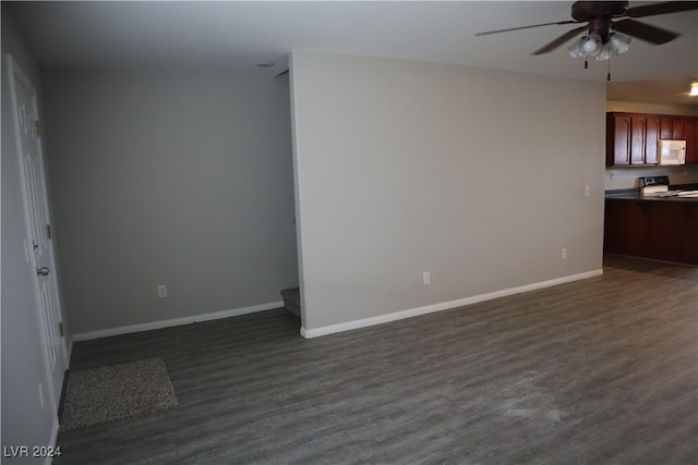 empty room with ceiling fan and dark hardwood / wood-style floors