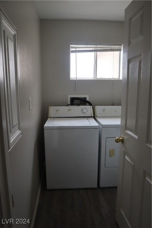 laundry area featuring dark wood-type flooring and washer and clothes dryer