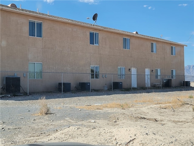 rear view of property featuring cooling unit