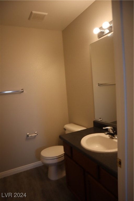 bathroom featuring toilet and vanity