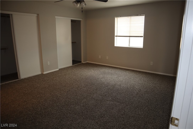 interior space with carpet floors and ceiling fan