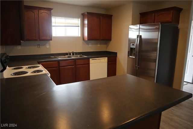 kitchen featuring sink, wood-type flooring, white dishwasher, stainless steel fridge with ice dispenser, and stove