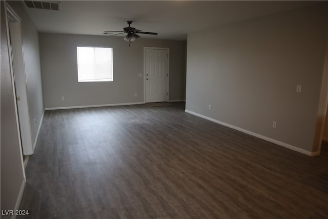 spare room featuring ceiling fan and dark wood-type flooring