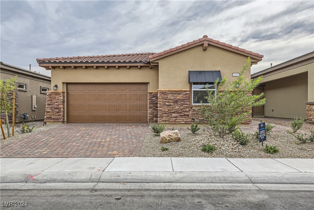 mediterranean / spanish-style home featuring a garage