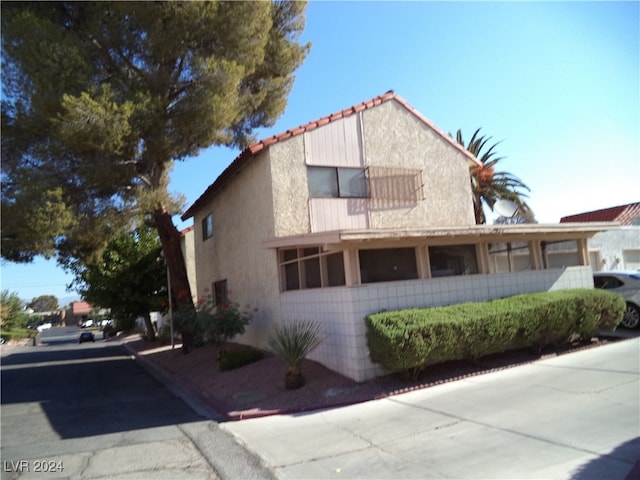 view of side of property with a balcony