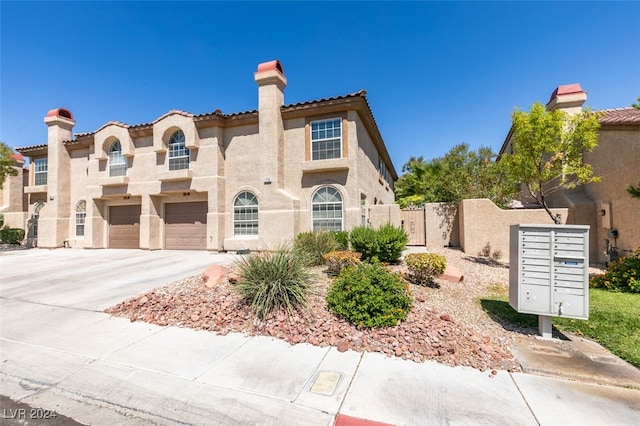 mediterranean / spanish-style house with a garage