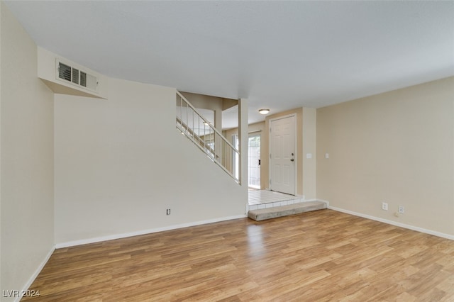 empty room with light hardwood / wood-style flooring