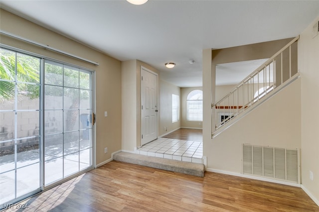 foyer with hardwood / wood-style floors and a healthy amount of sunlight