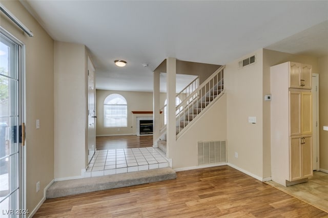 foyer entrance featuring light wood-type flooring and a healthy amount of sunlight