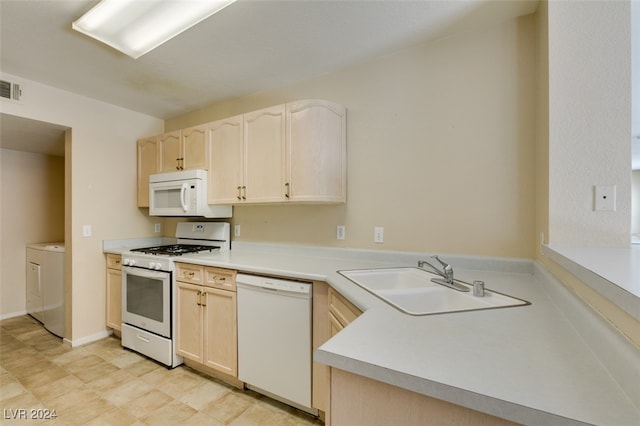 kitchen featuring light brown cabinetry, light tile patterned floors, white appliances, sink, and washer / dryer