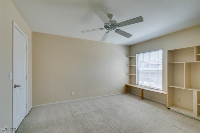 unfurnished bedroom with ceiling fan and light colored carpet