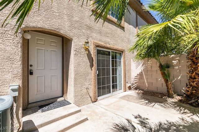 view of exterior entry featuring a patio