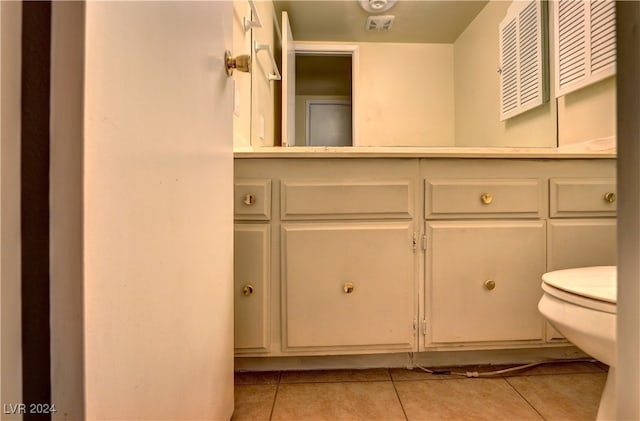 bathroom featuring toilet, tile patterned flooring, and vanity