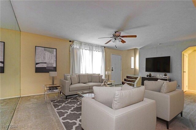 living room with ceiling fan and carpet