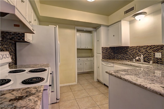 kitchen featuring white appliances, decorative backsplash, white cabinets, and under cabinet range hood