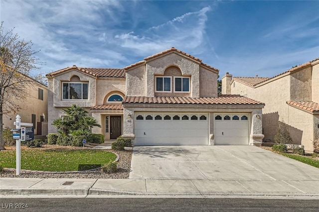 mediterranean / spanish home with a garage