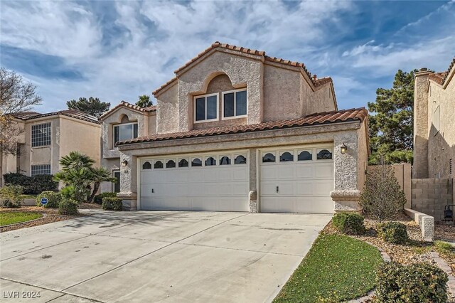 mediterranean / spanish-style home featuring a garage