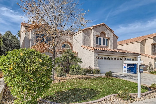 mediterranean / spanish house with a front yard and a garage