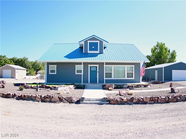 view of front facade featuring an outdoor structure, a garage, and a porch