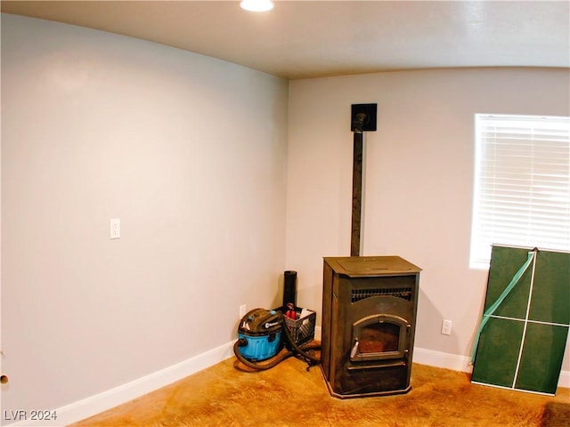 interior details with a wood stove, recessed lighting, and baseboards