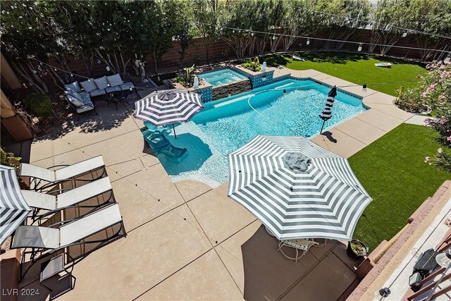 view of pool with a lawn, a patio area, and an in ground hot tub