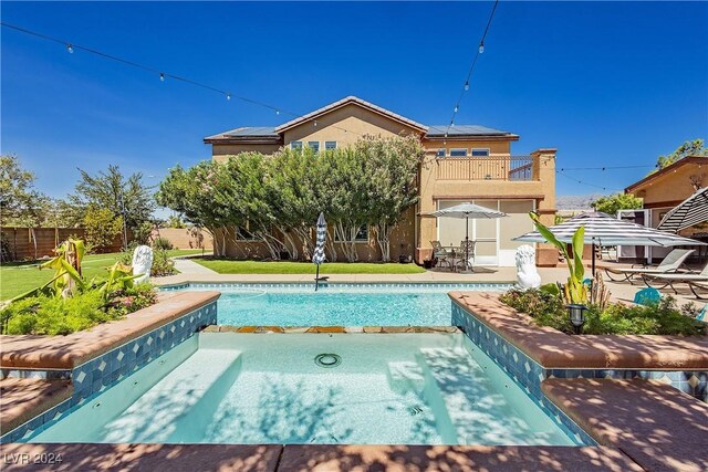 view of pool with a yard