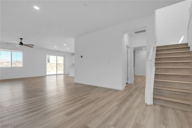 unfurnished living room featuring light wood-type flooring and ceiling fan