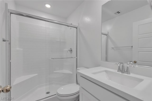 bathroom with vanity, toilet, and an enclosed shower