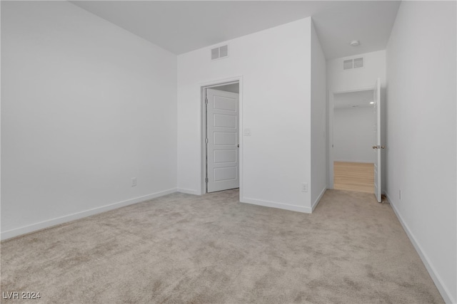 unfurnished bedroom featuring light carpet